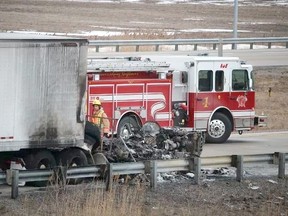 Fire and police officials on the scene of a fatal transport fire on westbound Highway 402, south of Sarnia, on Jan. 31, 2016. (BARBARA SIMPSON, Sarnia Observer)