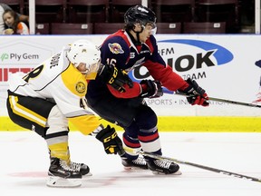 Windsor Spitfires' Chris Playfair, right, fends off Sarnia Sting's Alexandre Hogue in the second period of an OHL exhibition game at Progressive Auto Sales Arena in Sarnia, Ont., on Saturday, Sept. 16, 2017. (Mark Malone/Chatham Daily News/Postmedia Network)