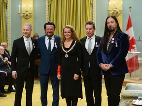 Julie Payette, Governor General of Canada, presents the insignia of the Order of Canada to members of The Tragically Hip Johnny Fay, left to right, Paul Langlois, Gord Sinclair and Rob Baker, at Rideau Hall in Ottawa on Friday. THE CANADIAN PRESS/Sean Kilpatrick