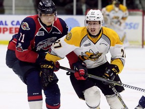 Windsor Spitfires' Lev Starikov (71) tries to slow Sarnia Sting's Sean Josling (27) in the first period at Progressive Auto Sales Arena in Sarnia, Ont., on Friday, Nov. 17, 2017. (Mark Malone/Chatham Daily News/Postmedia Network)