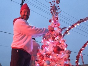 Luc Chartrand, principal of French language Catholic secondary school Monseigneur-Bruyere, decorates a tree for the school's float in the London Santa Claus parade.