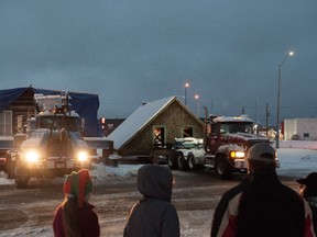 Onlookers watch as the birth home of the Dionne quintuplets begins its journey to its new location in North Bay, Ont., Sunday, Nov.19, 2017. THE CANADIAN PRESS/Galit Rodan