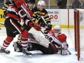 Kingston Frontenacs’ Tyler Burnie gets the puck past Ottawa 67’s goalie Cedrick Andree as Kevin Bahl comes in late to help during Ontario Hockey League action at the Rogers K-Rock Centre on Sunday. (Ian MacAlpine/The Whig-Standard)