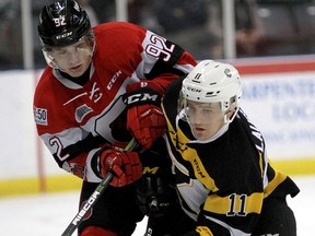 Ottawa 67s Graeme Clarke, left, and Kingston Frontenacs Bryan Laureigh collide Ottawa 67s Ontario Hockey League action at the Rogers K-Rock Centre on Sunday November 19 2017. Ian MacAlpine /The Whig-Standard/Postmedia Network