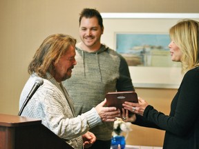 Goodwill Industries - Essex Kent Lambton employment consultant Lisa Gagner-Carr, right, presents Daniel Hawkins, left, with a Gifford Goodwill Award during the organization's Appreciation Luncheon at the John D. Bradley Convention Centre Nov. 17, 2017. Blazin BBQ owner Matt Jenkins, centre, also received the award for hiring Hawkins though Goodwill's services earlier this year.