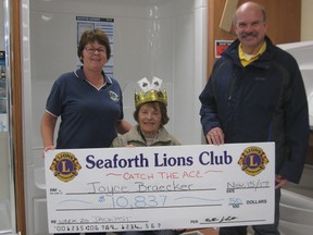 Catch the ’Ace’ jackpot winner Joyce Braecker proudly wears the ’Ace’ of Spades crown as she accepts her $10,837 cheque from Lions Club members Dave Harper and Cathy Elliott. (Submitted photo)