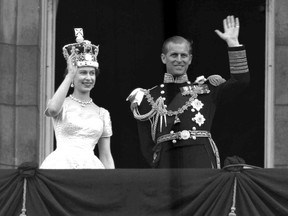 This is a June. 2, 1953 file photo of Britain's Queen Elizabeth II and Prince Philip, Duke of Edinburgh, as they wave to supporters from the balcony at Buckingham Palace, following her coronation at Westminster Abbey. London. (AP Photo/Leslie Priest, File)