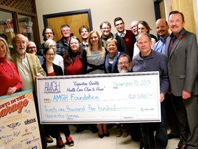 Members of the Guys in the Garage cast and crew present members of the AMGH Foundation Board of Directors with the proceeds of the show. (Contributed photo)