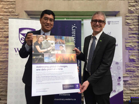 Western University president Amit Chakma and Christian Nelissen, a TD Bank vice-president, on Monday jointly announced a $1-million investment by the bank into data analytics teaching and research in Western?s faculty of science. They are holding a copy of an advertisement that will soon be published.