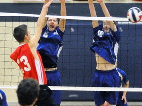 Darren Dixon (5) and Kyle Eisler (10) of the Mitchell District High School (MDHS) junior boys volleyball team leap high for a block against Lord Dorchester during action from the WOSSAA ‘A’ championships at MDHS last Thursday morning, Nov. 16. ANDY BADER/MITCHELL ADVOCATE