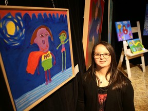 Elliot Ferguson/The Whig-Standard
Ashaya Garrett stands next to her painting at the H’art Centre’s fundraising kickoff on Saturday.