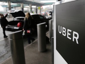 In this March 15, 2017, file photo, a sign marks a pick up point for the Uber car service at LaGuardia Airport in New York. (AP Photo/Seth Wenig, File)