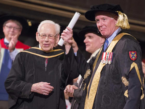 Bruce Jameson, left, receives his engineering degree from Chancellor Jim Leech during a recent convocation at Queen's University in Kingston. The 93-year-old retired Imperial Oil researcher got it 70 years after leaving school one credit short.