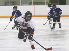 Hawks novice player Dryden Scobie about to take control of the puck during a game against the High Country Rockies Saturday, Nov. 18 at the Vulcan District Arena. The Hawks won 15-0.