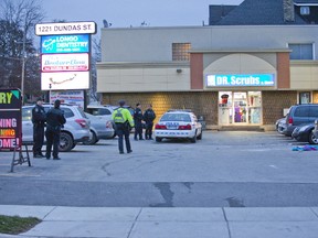 Police investigate a fatal hit-and-run in a plaza parking lot at 1221 Dundas St. in London, Ont. on Tuesday, November 21, 2017. (DEREK RUTTAN, The London Free Press)