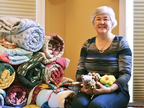 Margaret Campbell in her Chatham home with blankets and stuffed animals she will bring on her next visit to Belarus to aid victims of the 1986 Chernobyl accident. Campbell has raised funds through the charity Canadian Aid for Chernobyl for the last 12 years.