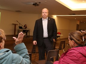 Jason Miller/The Intelligencer 
Coun. Paul Carr talks with residents during a meeting held in Thurlow to preview the 2018 capital budget Wednesday night.