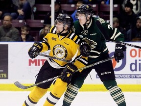 Sarnia Sting's Curtis Egert (23) and London Knights' Tim Fallowfield (77) battle for position in the first period at Progressive Auto Sales Arena in Sarnia, Ont., on Wednesday, Nov. 22, 2017. (Mark Malone/Postmedia Network)