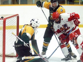 Wallaceburg Lakers goalie Travis Moore stops a Mooretown Flags player from in close during a game held at Wallaceburg Memorial Arena on Wednesday, Nov. 22. The Lakers beat the Flags 3-1.