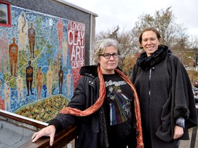 Visual artists Susan Day (left) and Beth Turnbull Morrish stand near a 900-square-foot mosaic they recently completed on the side of the London Clay Art Centre in Old East Village. The Canada 150 project took eight months to complete and also included 650 local volunteers. (CHRIS MONTANINI\LONDONER\POSTMEDIA NETWORK)