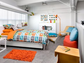 AFTER: Kid-friendly artwork and accessories, a jaunty lamp, wicker floor chair and bedding featuring stylized cars give the room a vibrant look.