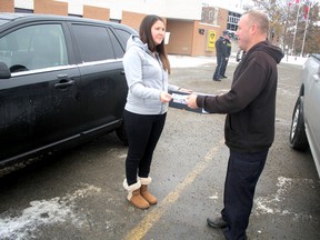 Autumn Begin and Carey Bock simulate an exchange at Ontario Provincial Police detachment in Sault Ste. Marie.