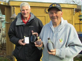 Dick Williams, left, and Jack Lea, hold bottles of Point Edward Gold, maple syrup made from the sap of Point Edward maple trees. A group of volunteers gathered sap around the village to make syrup given away in exchange for donations expected to raise approximately $600 this year for St. Joseph's Hospice and the Inn of the Good Shepherd. (Paul Morden/Sarnia Observer/Postmedia Network)
