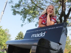 Natalie Andrews, president of the MADD Sarnia-Lambton Chapter, is shown in this file photo with a MADD bench located on the waterfront in Centennial Park. Andrews and the chapter are currently hoping to hear from the person who may have lost a diamond ring found among coins and bills donated during last weekend's MADD voluntary tolls fundraiser. (File photo/Sarnia Observer/Postmedia Network)