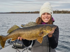 Columnist Ashley Rae holds a walleye caught and released on the Bay of Quinte. (Submitted photo)