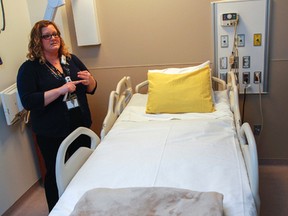 Melanie Rudd, clinical subject matter expert and nurse at Providence Care Hospital, demonstrates the features of one of the new state-of-the-art beds in the complex medical ward in Kingston on Thursday. The hospital volunteers donation of $70,000, announced Thursday, will be going toward the purchase of five specialty beds for the local hospital. (Julia McKay/The Whig-Standard)