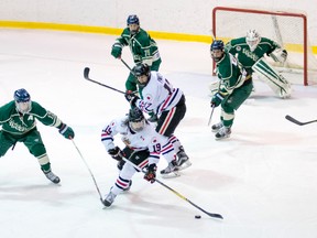 Joey Zappa of the Sarnia Legionnaires (No.19 in white) reaches for a loose puck in front of the St. Marys Lincolns net Thursday. Sarnia won the Jr. 'B' hockey game 4-2. (Photo courtesy of Shawna Lavoie)