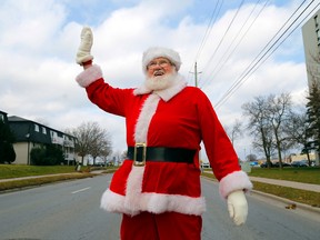 Luke Hendry/The Intelligencer
Jim Brennen, known better as the Sidney Street Santa Claus, crosses the street Friday in Belleville. It was the first day of the last season in his 25-year hobby of greeting passersby.