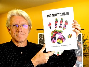 Sandy Singers, executive director of the Partners inn Mission Food Bank with the book, the Artist's Hand, which is a on sale to raise funds for the food bank in Kingston on Friday November 24 2017. Ian MacAlpine /The Whig-Standard/Postmedia Network