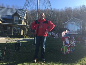 Dennis Taylor is working hard to get the lights on his home ready for Saturday when the holiday light display starts. Taylor and Raymie Jewell have donated almost $52,000 to Make-A-Wish Southwestern Ontario through donations from their light display. (Laura Broadley/Times-Journal)