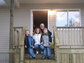 In 2009, Becky Doyle, with sons Reilly and Levi, celebrate owning their own home in Ingersoll through Habitat for Humanity, who are looking for an eligible family in Tillsonburg to build a home in 2018. (Heather Rivers/Postmedia Network)