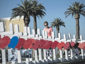A woman pauses while looking at some of the 58 white crosses for the victims of Sunday night?s mass shooting, on the south end of the Las Vegas Strip in the says after Oct. 1 when Stephen Paddock opened fire on a large crowd at the Route 91 Harvest country music festival. The massacre is one of the deadliest mass shooting events in U.S. history.  (Drew Angerer/Getty Images)