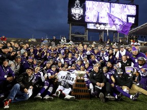 The Western Mustangs celebrate with the Vanier Cup at Tim Hortons Field in Hamilton, Ont. They defeated the Laval Rouge et Or 39-17. Mike Hensen/The London Free Press/Postmedia Network
