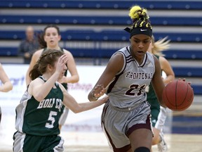 Frontenac Falcons’ Aaliyah Edwards tries to get past Holy Cross Crusaders’ Taylor Robertson during the Kingston Area Secondary Schools Athletic Association senior girls basketball championship game at the Queen's Athletics and Recreation Centre on Nov. 13. Edwards scored 25 points in the final to help the Falcons win the provincial AA title on Saturday. (Ian MacAlpine/Whig-Standard file photo)