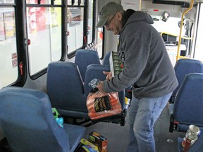 Art Lloyd drops off a food donation at the Stuff the Bus event at Grant's No Frills on Saturday. (Steph Crosier/The Whig-Standard)