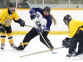 Taryn Lavallee of the Valley East 18+ ringette team battles for the ring with Austin Corcoran and Bryce Robert of the Iroquois Falls Lady Eskis ringette team during 18+ semifinal action at the Sudbury Invitational Ringette Tournamentin Sudbury, Ont. on Sunday November 26, 2017. Gino Donato/Sudbury Star/Postmedia Network