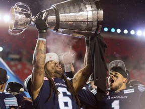 Toronto Argonauts linebacker Marcus Ball and running back Anthony Coombs celebrate with the Grey Cup on Nov. 26, 2017 (CP)