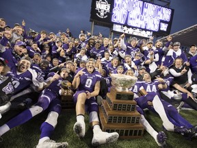 The Western Mustangs pose for a team photo with the Vanier Cup after defeating the Laval Rouge et Or in Hamilton on Saturday, Nov. 25, 2017. (Peter Power/The Canadian Press)
