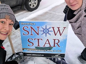 Volunteers from the Whitecourt Hot Rollers pose with a Snow Stars sign after clearing a resident's driveway and walkway. Snow Stars clear a path for seniors and residents with mobility issues, helping to reduce isolation during the winter (Submitted).