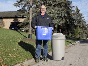 Brian Orchard has helped his son Tyler get his Bin Rescue product ? a stake  and elastic tether that prevents blue bins and garbage cans from blowing away ? to market. Bin Rescue can be ordered online at www.binrescue.ca. (Derek Ruttan/The London Free Press)