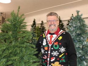Claude Rocheleau, Manager of the Cochrane Food Bank stands among the forest of Christmas trees that were availalbe for sale during the annual Food Bank Christmas Sale, where hundreds of people took advanatage of all the great Christmas supplies.