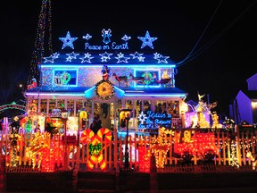 In this 2011 photo visitors look at the lights at 226 Roseville Terrace in Fairfield, Conn. (Christian Abraham/Hearst Connecticut Media via AP)