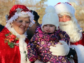 TIM MEEKS/THE INTELLIGENCER
Santa and Mrs. Claus pose with Tulla Walmsley, 17 months, during CP Rail's 19th annual Holiday Train cross Canada tour Tuesday along Belleville's Bayshore Trail.