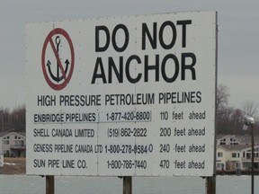 A sign near Corunna, south of Sarnia, Ont., marks where several pipelines cross the St. Clair River from Michigan to Ontario. Enbridge has agreed to replace a section of its Line 5 pipeline where it crosses the St. Clair River, as part of a deal signed Monday with the State of Michigan. (File photo/Sarnia Observer/Postmedia Network)