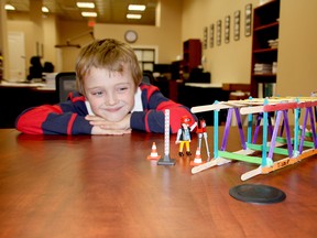Five-year-old Liam Jahns of Chatham is shown with his popsicle stick truss bridge, which took second place at a recent engineering competition at the University of Windsor.