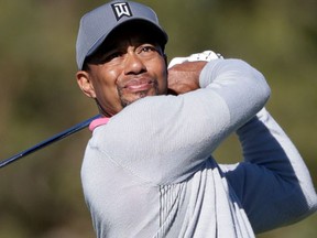This file photo taken on February 1, 2017 shows Tiger Woods of the United States playing a shot during the Dubai Desert Classic golf tournament at the Emirates Golf Club in Dubai (AP)